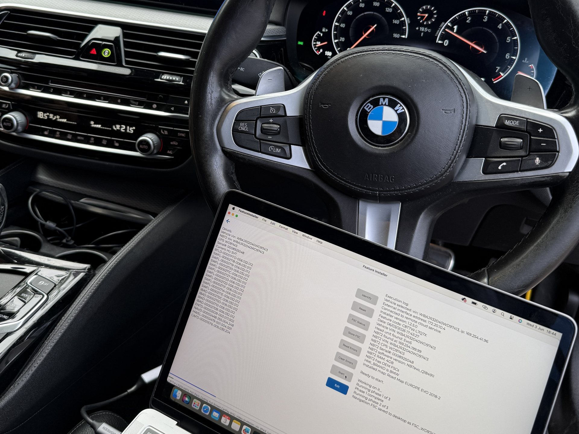 Technician performing mobile BMW coding service
