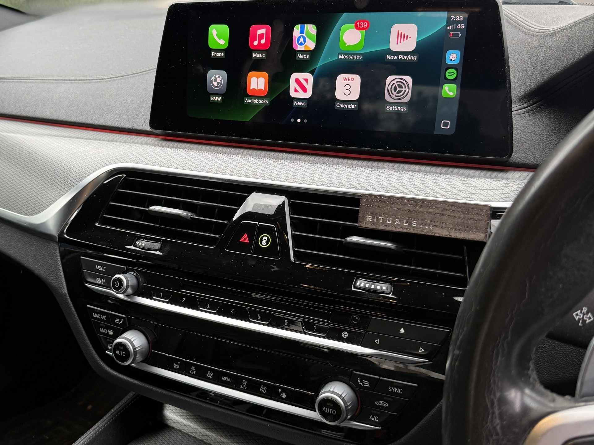 CarPlay activated alongside factory BMW apps and navigation.
