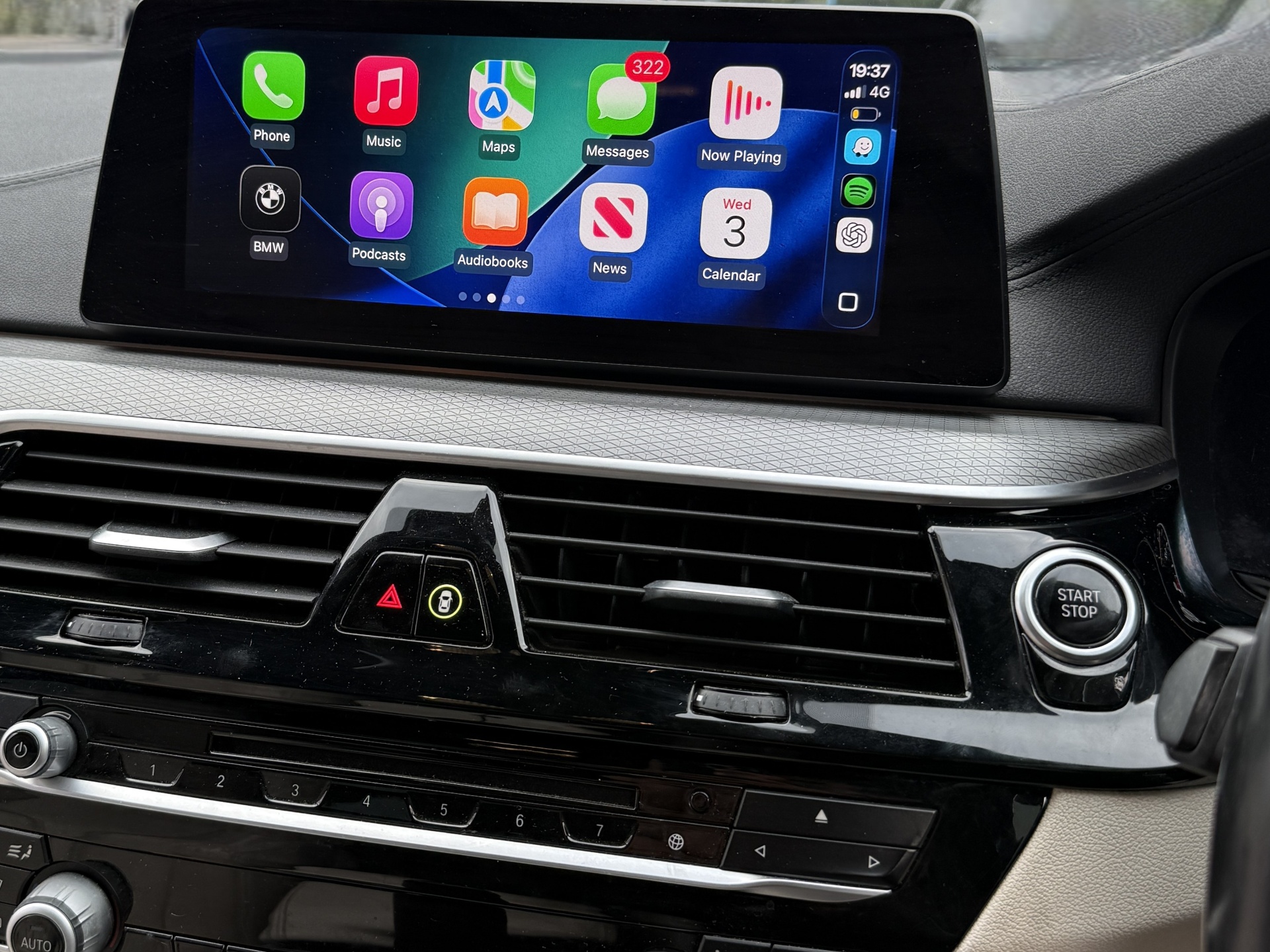 Apple CarPlay with Waze, Spotify and BMW apps side-by-side.